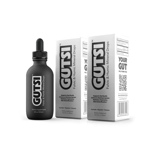 A black dropper bottle labeled GUTSI next to two white product boxes with large black GUTSI branding, shown on a clean white background.